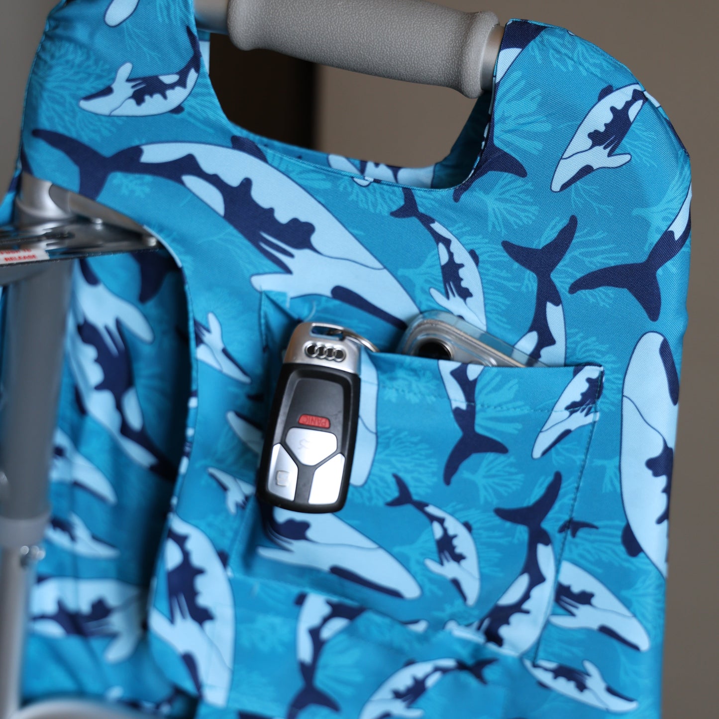 Close up of inside pocket of Whale Dance Jover Walker Cover filled with keys and phone.