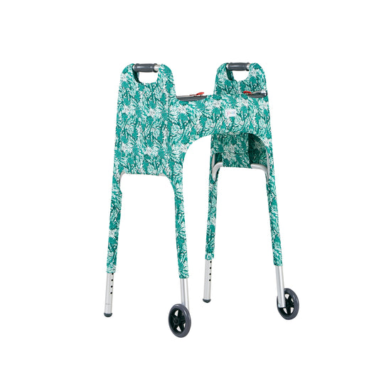 Front left view of a green and white tropical foliage print walker cover on a standard folding walker highlighting a large outside pocket and the Jover logo label. The ultimate walker accessory.