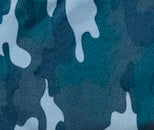 Fabric swatch detail of the Jover Walker Cover in Woodland Camo, a blend of shades of green and gray that evokes nature. This cover, equipped with four convenient pocket, is the only walker accessory you need when enjoying the great outdoors.